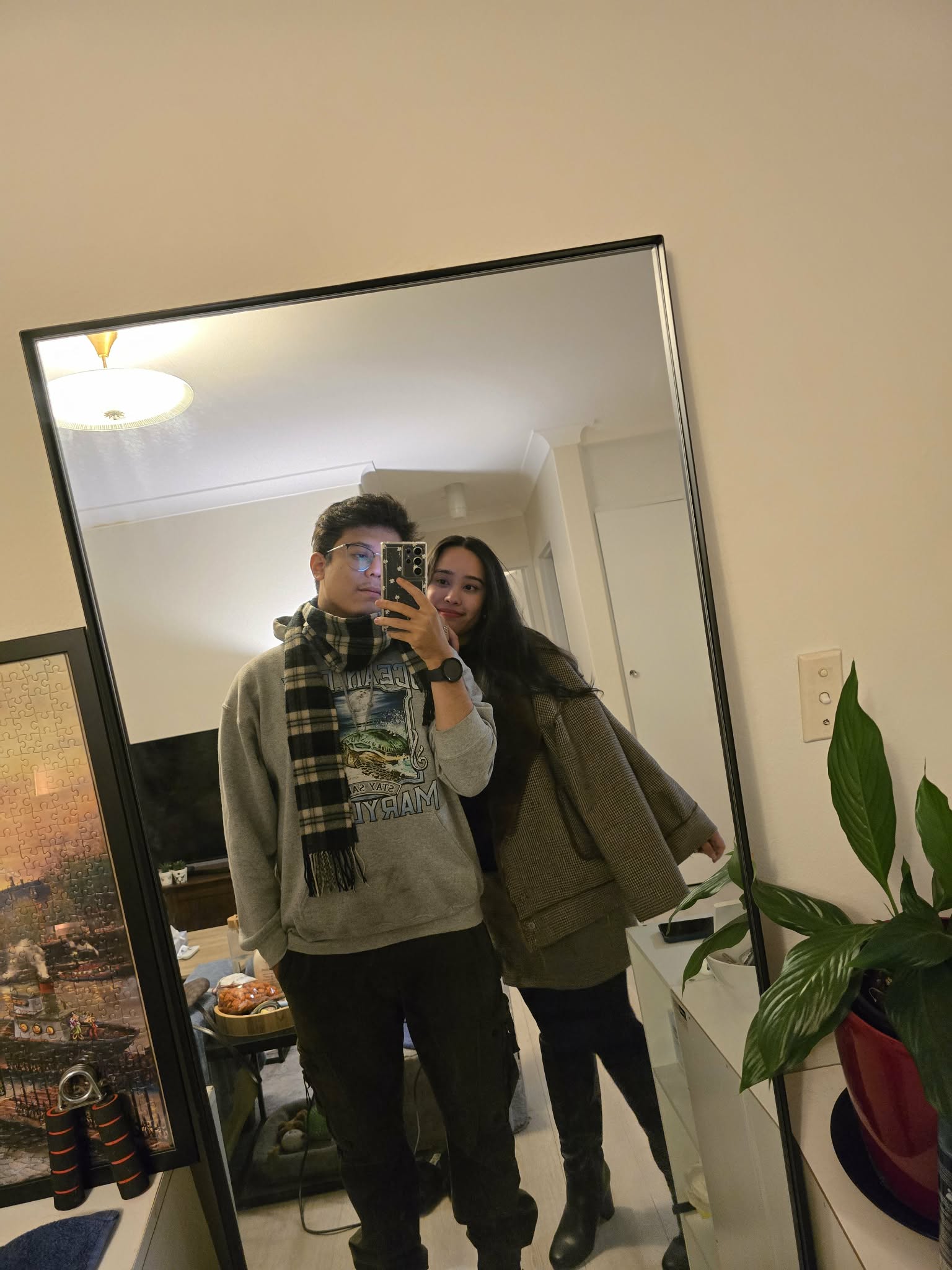 Abhishek and Alyssa taking a mirror selfie at home