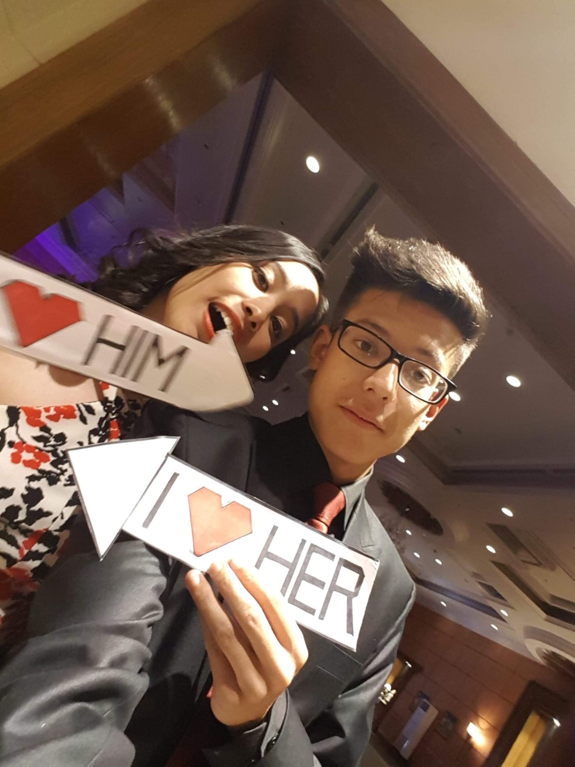 Abhishek and Alyssa holding playful heart signs