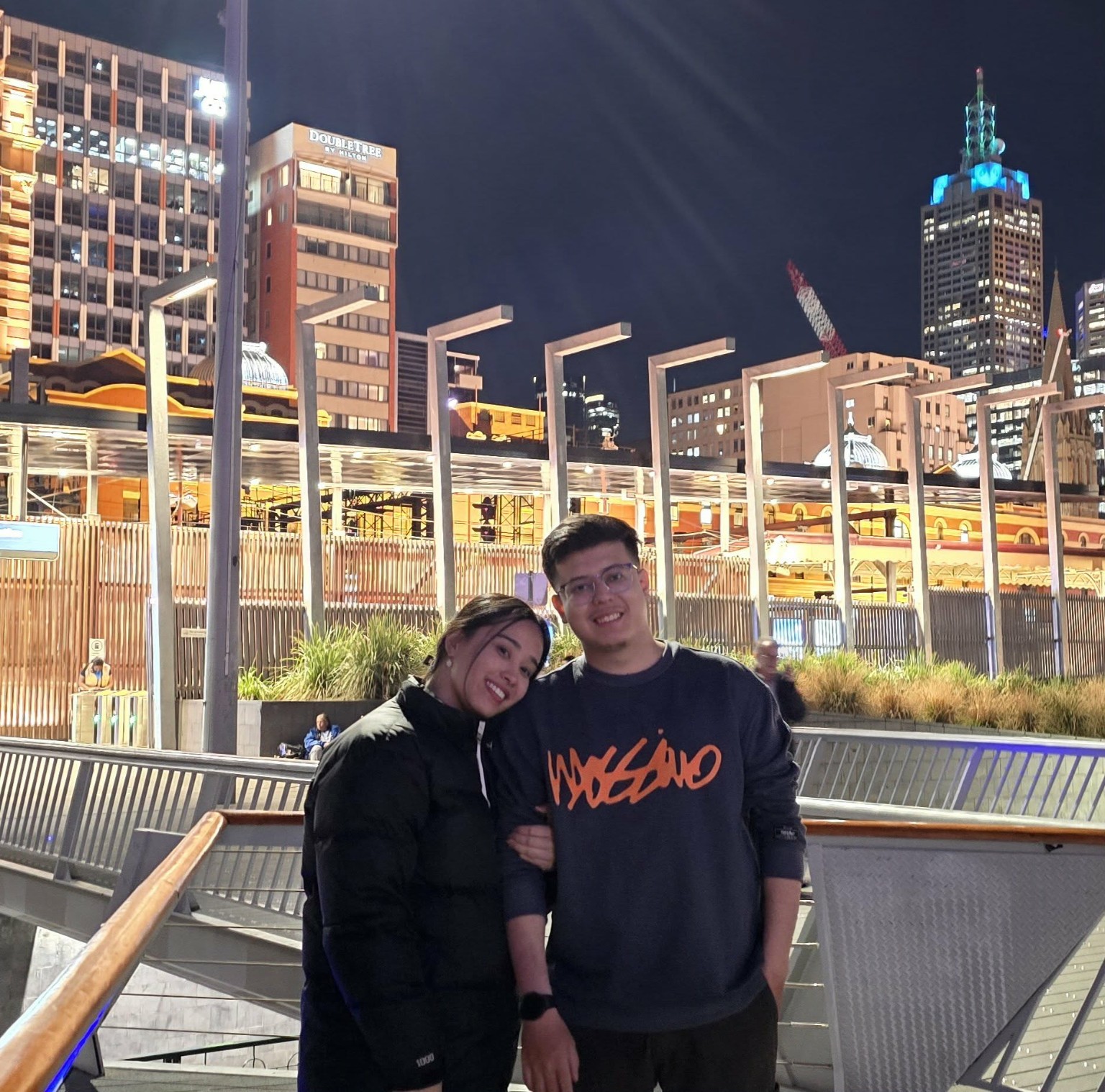 Abhishek and Alyssa together in the city at night
