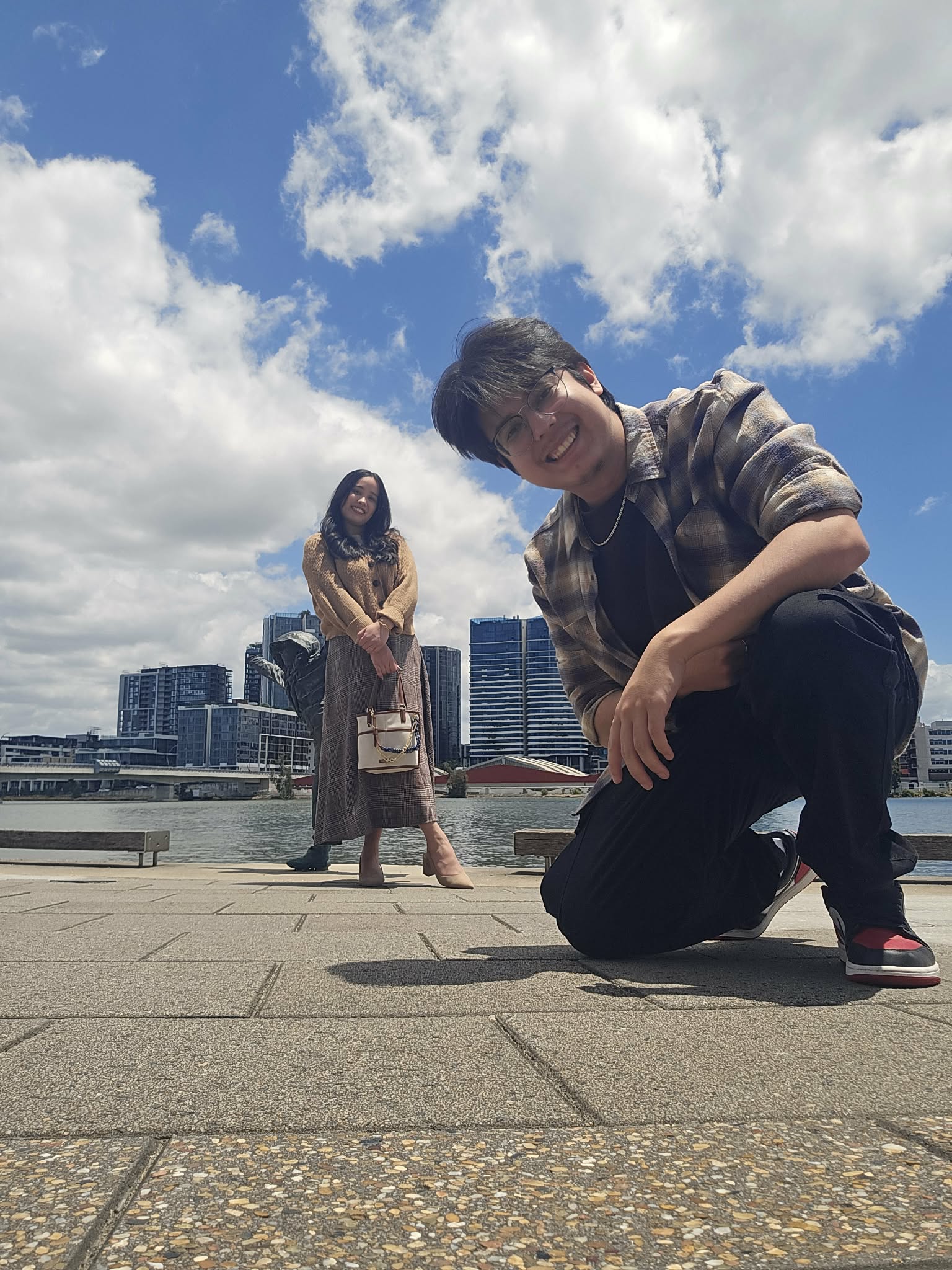 Abhishek and Alyssa beside the waterfront on a sunny day